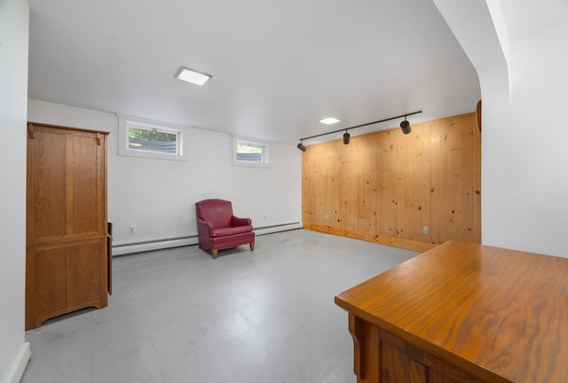 living area featuring rail lighting and a baseboard radiator