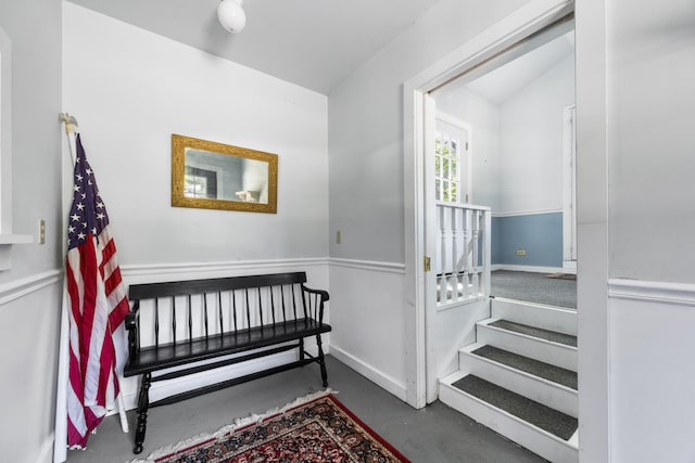 bedroom featuring vaulted ceiling and concrete floors