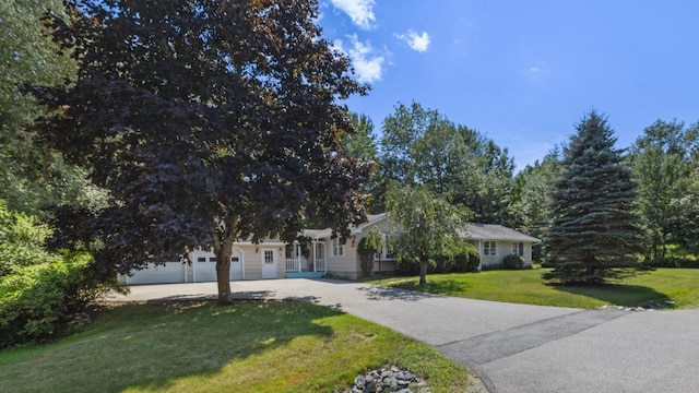 view of front of property with a front lawn and a garage