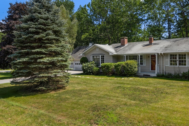 ranch-style home with a garage and a front lawn