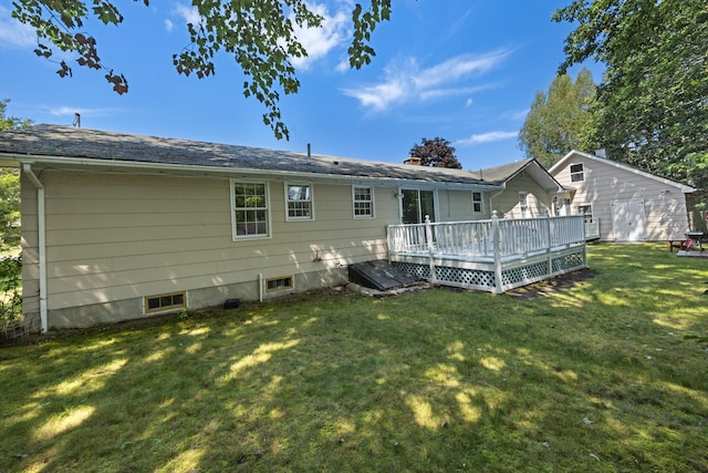 back of property with a lawn and a deck