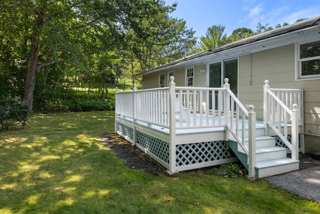 wooden terrace featuring a lawn