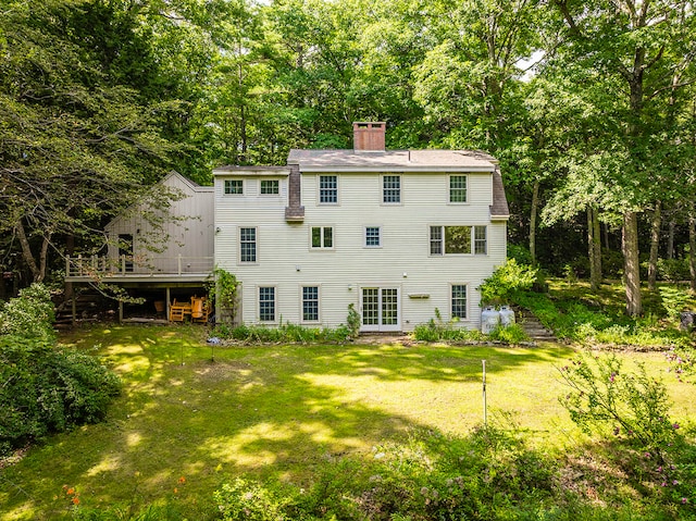 rear view of property with a yard