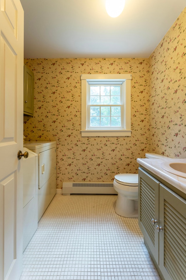 bathroom featuring a baseboard radiator, toilet, tile patterned floors, vanity, and independent washer and dryer