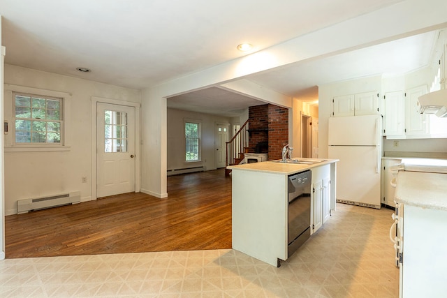 kitchen featuring light hardwood / wood-style flooring, dishwasher, brick wall, white fridge, and a baseboard heating unit