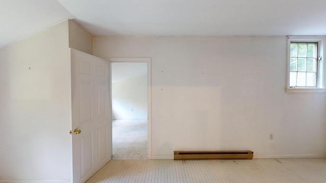 carpeted spare room featuring a baseboard radiator