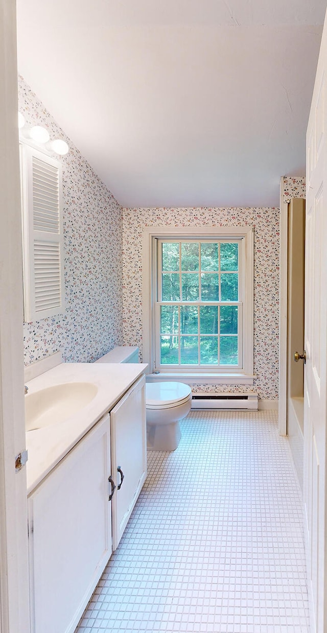 bathroom featuring tile patterned floors, a baseboard heating unit, vanity, and toilet