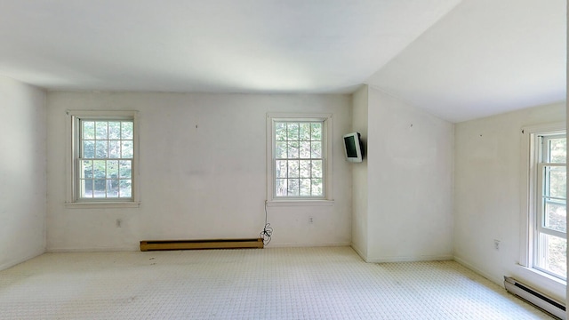 spare room with a baseboard heating unit and a wealth of natural light