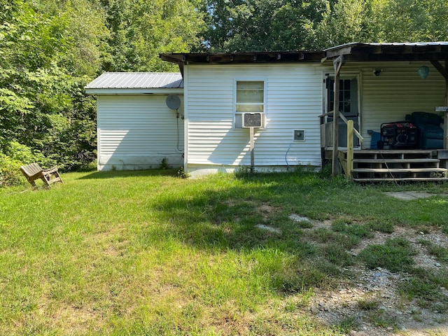 back of house with cooling unit and a yard