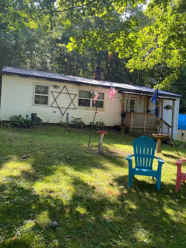 ranch-style home featuring a wooden deck and a front lawn