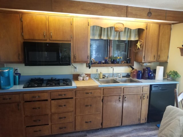 381 Caribou Rd, Presque Isle, ME 04769 - kitchen featuring black appliances, light countertops, and brown cabinetry