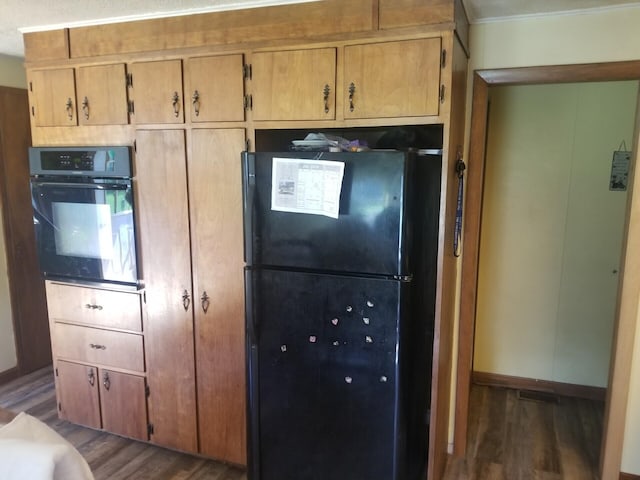 381 Caribou Rd, Presque Isle, ME 04769 - kitchen with black appliances and wood finished floors