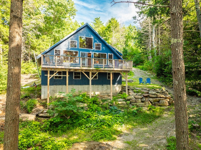 rear view of property featuring a wooden deck