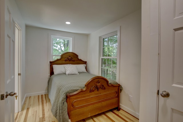 bedroom with light wood-style floors and baseboards