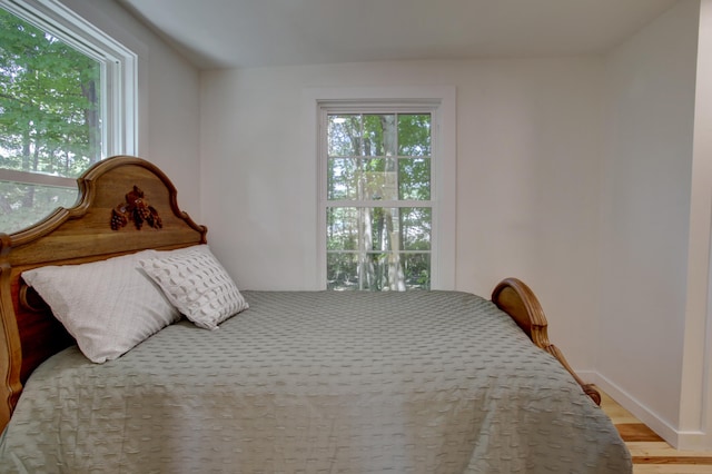 bedroom with light wood-style floors and baseboards