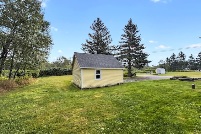 view of property exterior with a storage unit and a lawn