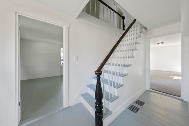 staircase featuring wood-type flooring