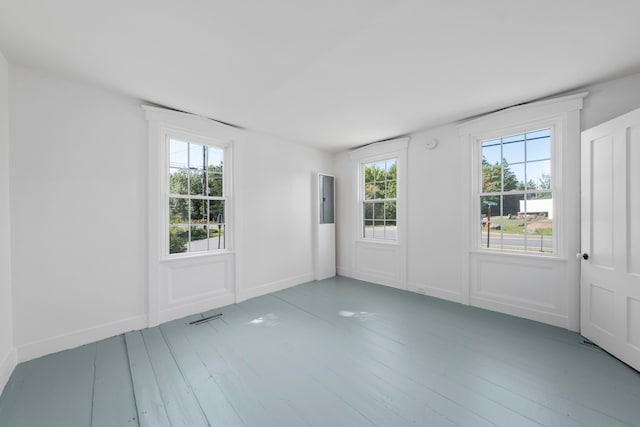 unfurnished room with hardwood / wood-style flooring