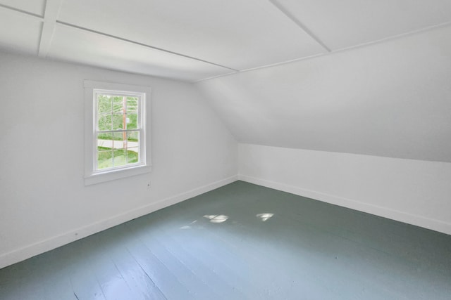 bonus room with lofted ceiling and hardwood / wood-style floors