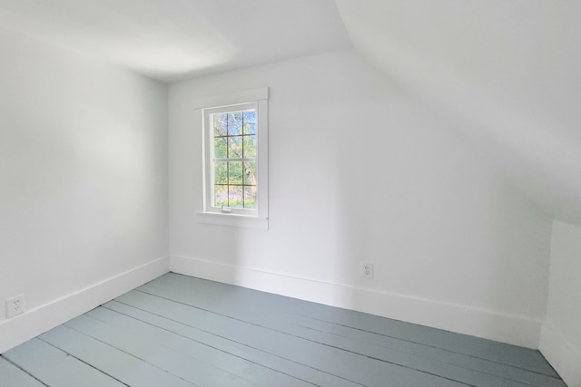 additional living space with vaulted ceiling and hardwood / wood-style flooring