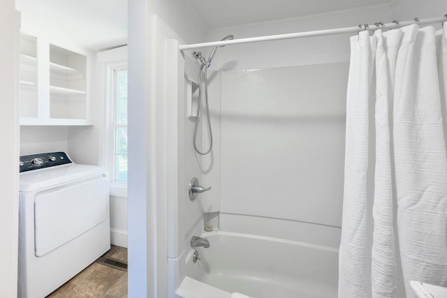 bathroom featuring washer / dryer and shower / bath combination with curtain