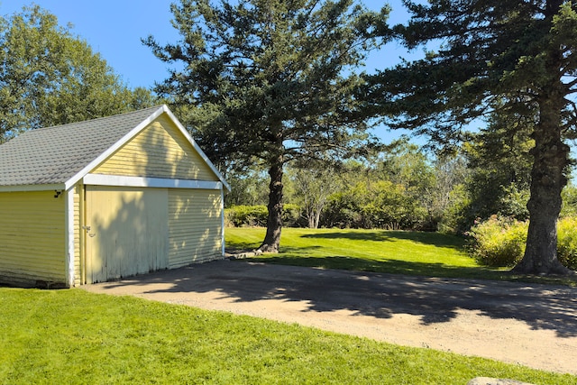 garage featuring a lawn