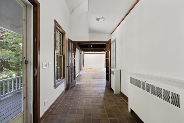 4 Wilson St, Topsham, ME 04086 - corridor featuring radiator, plenty of natural light, lofted ceiling, and dark tile patterned floors