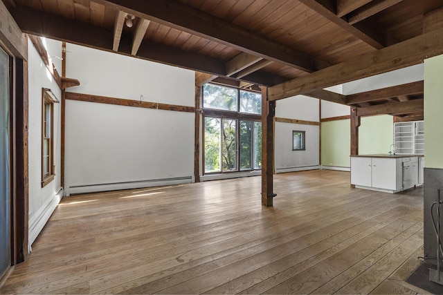 4 Wilson St, Topsham, ME 04086 - spare room featuring a baseboard heating unit, wood-type flooring, and a wood ceiling with exposed beams