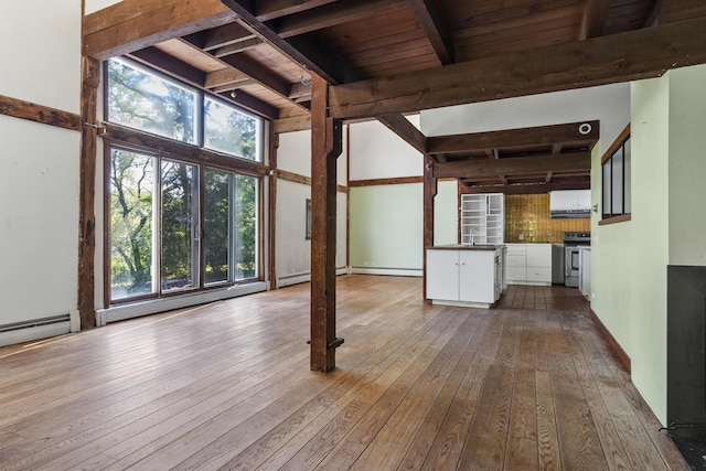 4 Wilson St, Topsham, ME 04086 - unfurnished living room featuring wood-type flooring, healthy amount of natural light, wood ceiling, and baseboard heating