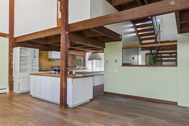 4 Wilson St, Topsham, ME 04086 - kitchen featuring wood finished floors, white cabinetry, plenty of natural light, and freestanding refrigerator