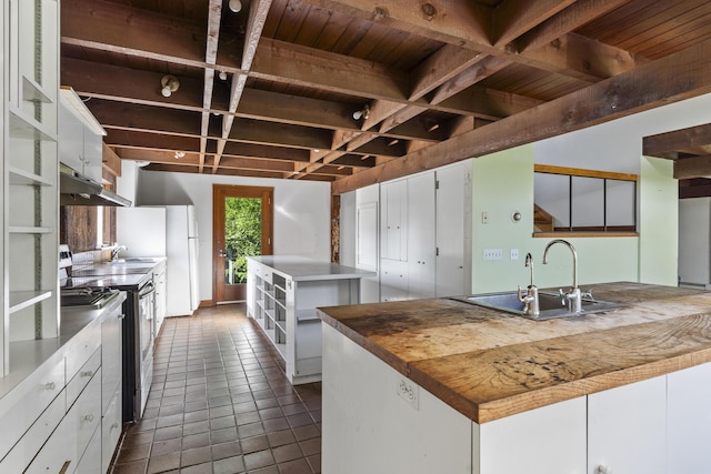 4 Wilson St, Topsham, ME 04086 - kitchen with under cabinet range hood, dark tile patterned flooring, open shelves, white cabinetry, and a wood ceiling with exposed beams