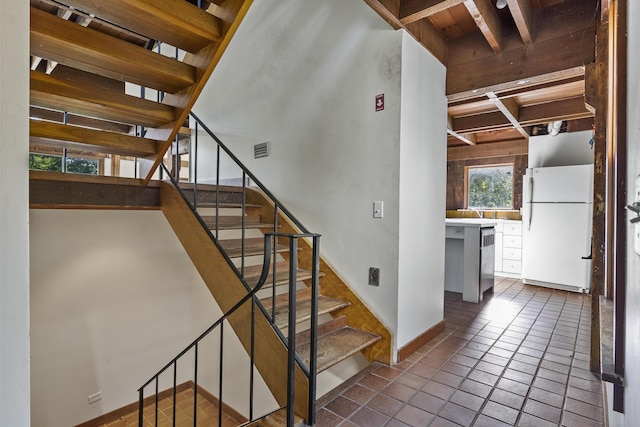 4 Wilson St, Topsham, ME 04086 - stairs featuring tile patterned flooring and baseboards
