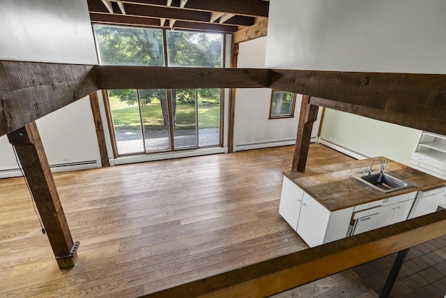 4 Wilson St, Topsham, ME 04086 - unfurnished living room with hardwood / wood-style flooring and a baseboard radiator