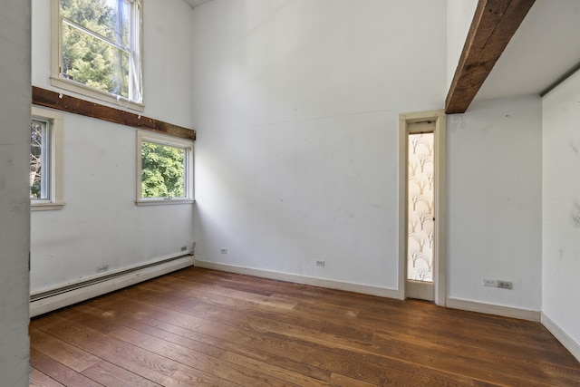 4 Wilson St, Topsham, ME 04086 - spare room with a baseboard radiator, hardwood / wood-style floors, and a towering ceiling