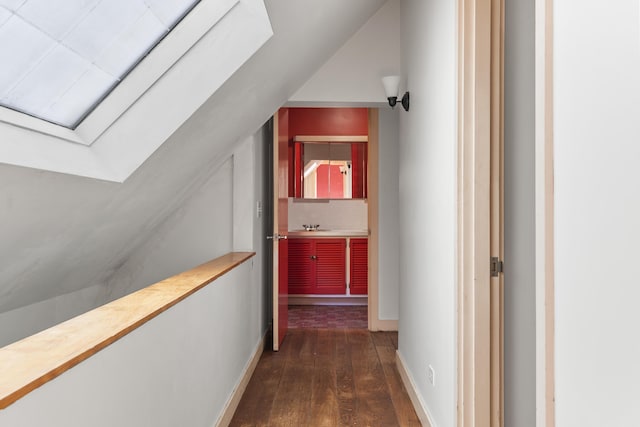 4 Wilson St, Topsham, ME 04086 - hallway featuring dark wood-style floors, lofted ceiling, and a skylight