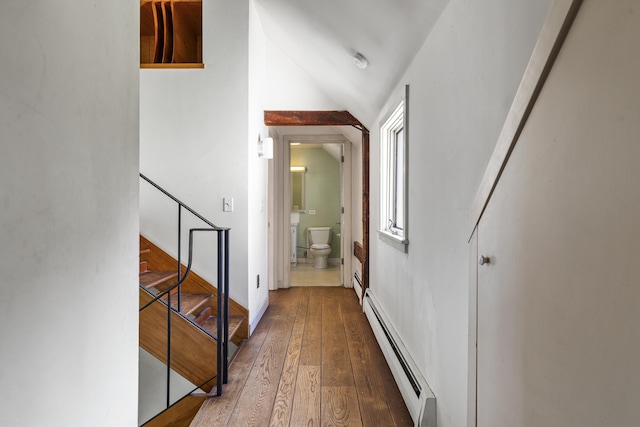 4 Wilson St, Topsham, ME 04086 - hallway with a baseboard heating unit, wood-type flooring, stairway, and vaulted ceiling