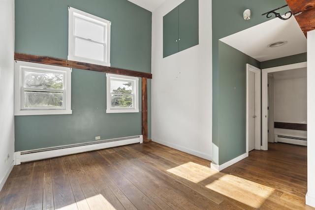 4 Wilson St, Topsham, ME 04086 - empty room featuring a baseboard radiator, hardwood / wood-style floors, and a smoke detector