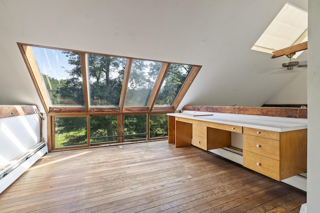 4 Wilson St, Topsham, ME 04086 - bathroom with a baseboard heating unit, a skylight, wood-type flooring, vaulted ceiling, and plenty of natural light