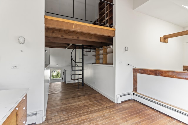 4 Wilson St, Topsham, ME 04086 - hallway with baseboard heating, wood finished floors, stairs, and beamed ceiling