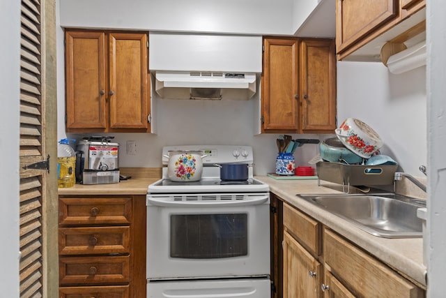 4 Wilson St, Topsham, ME 04086 - kitchen featuring electric stove, under cabinet range hood, brown cabinetry, and light countertops