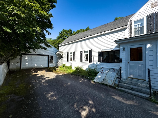 exterior space featuring a garage and an outdoor structure