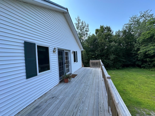 wooden deck featuring a lawn