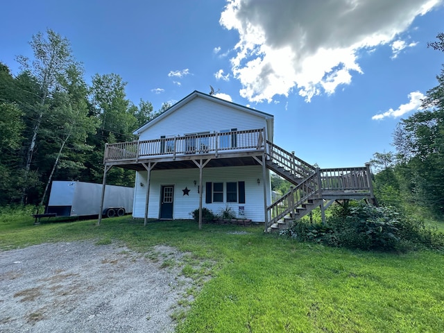 rear view of property with a yard and a wooden deck