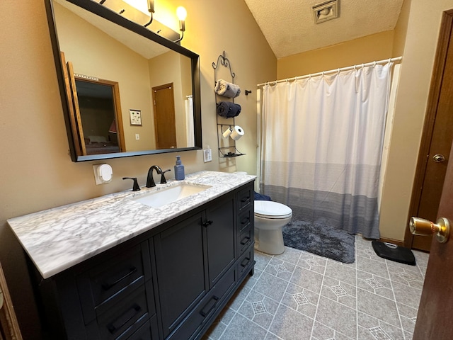 bathroom with a textured ceiling, toilet, tile patterned floors, vanity, and vaulted ceiling