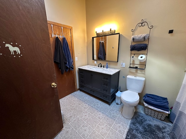 bathroom featuring vanity, toilet, and tile patterned flooring