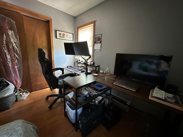 home office featuring wood-type flooring and a textured ceiling