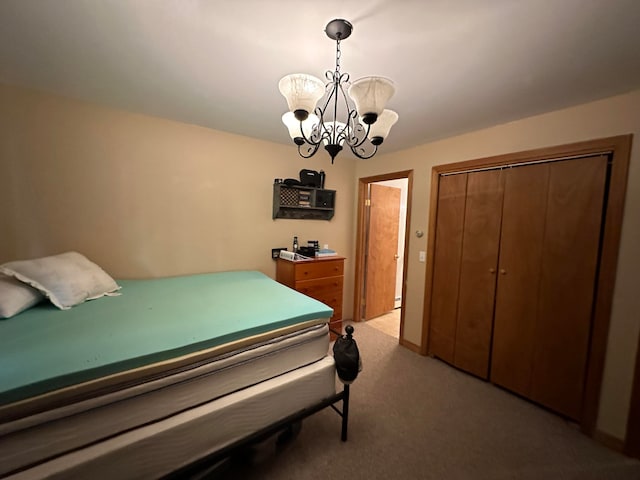 carpeted bedroom with a chandelier and a closet