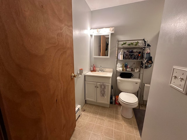 bathroom with tile patterned floors, a baseboard heating unit, vanity, and toilet