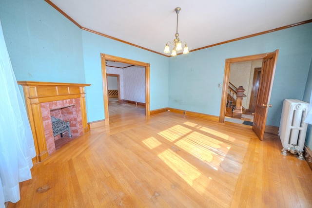 443 S Union Rd, Union, ME 04862 - unfurnished living room featuring an inviting chandelier, ornamental molding, light wood-style flooring, and radiator heating unit