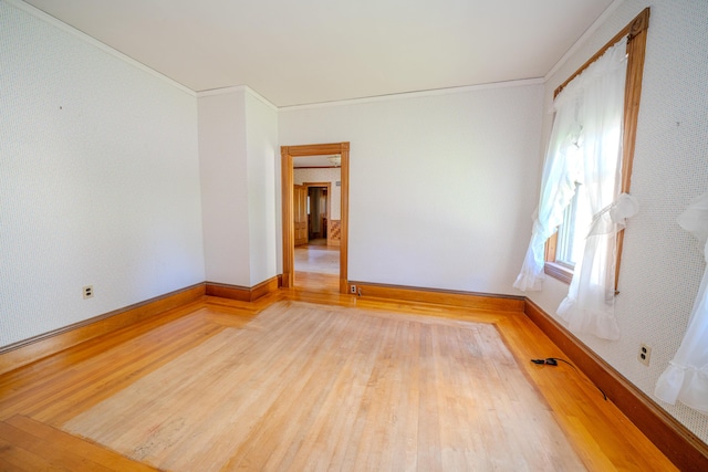 443 S Union Rd, Union, ME 04862 - unfurnished room featuring baseboards, crown molding, wallpapered walls, and wood finished floors